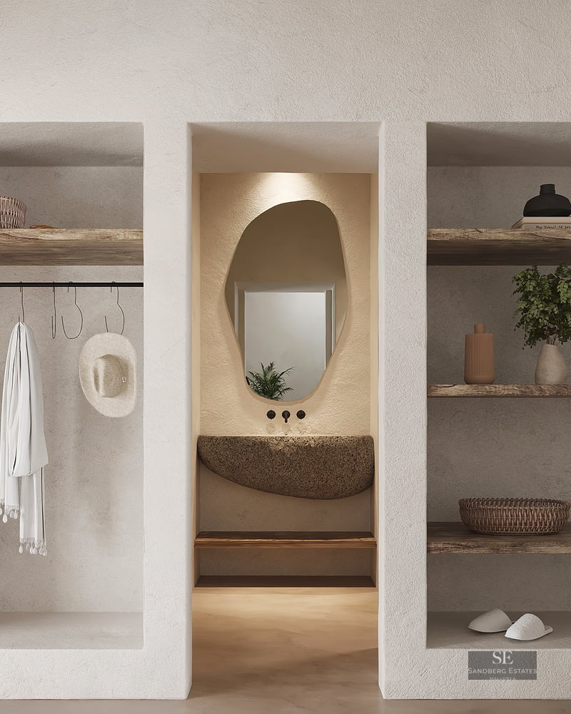 Walk-in closet featuring textured plaster walls, reclaimed wood shelves, a natural stone vanity, and an organic mirror.