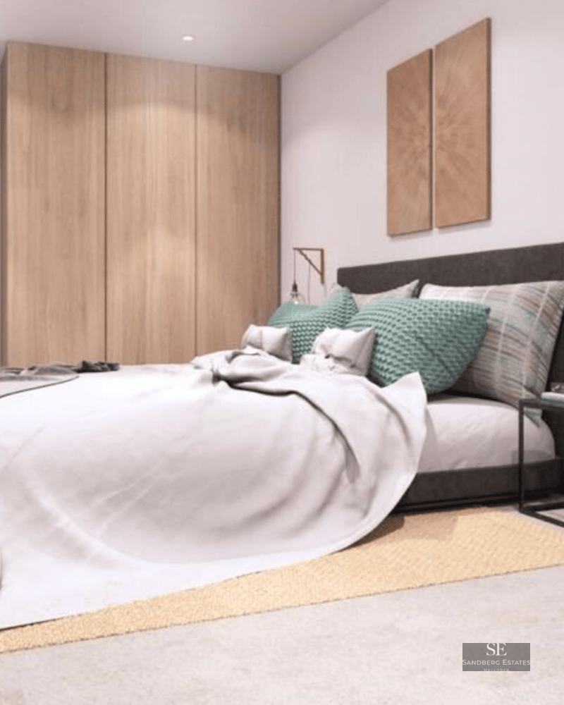 Bright bedroom featuring a large bed, built-in wooden wardrobe, teal pillows, and designer bedside lighting.