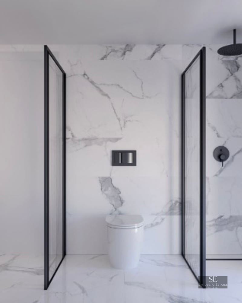 Contemporary bathroom featuring marble walls, a walk-in shower with black frames, and a wooden floating vanity.