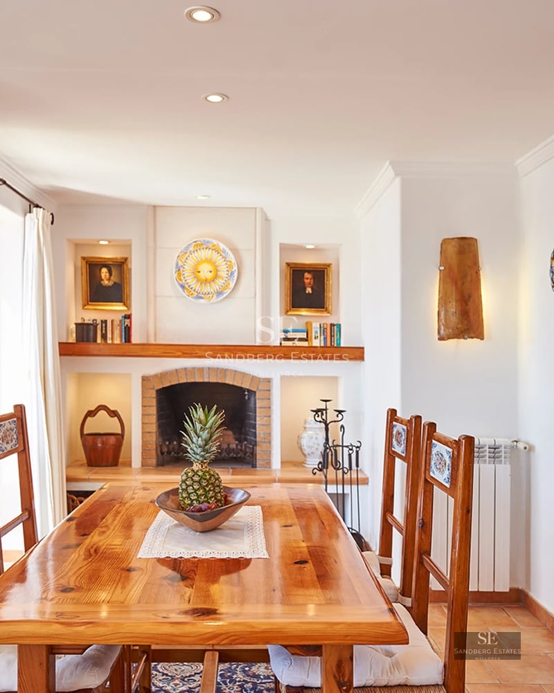 Modern living room with large windows, beige sofas, wooden coffee table, and minimalist decor. Natural lighting.