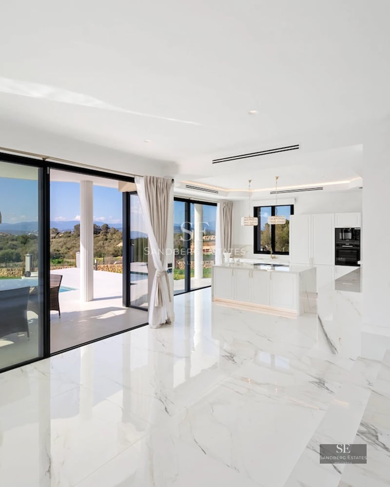 Spacious terrace with infinity pool and sea views. Modern design with stylish furniture and protective awning. Ambient lighting details.