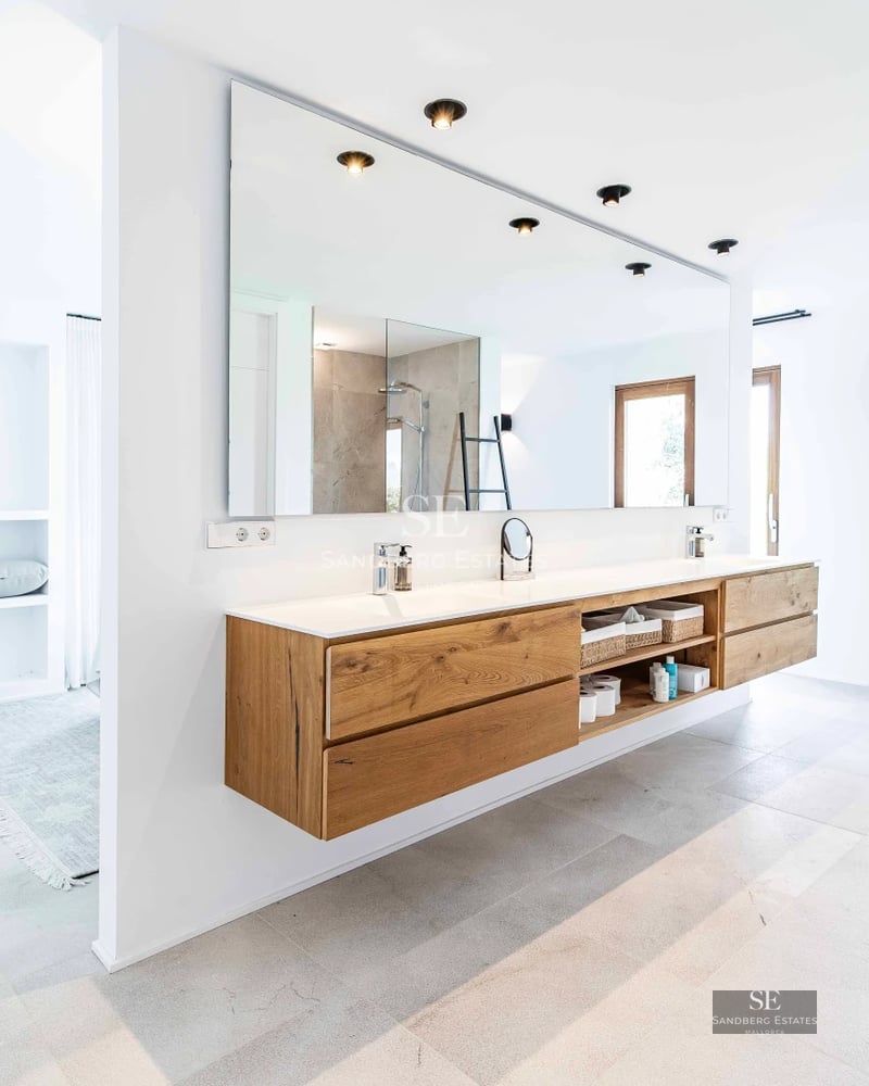 Villa view with pool. Modern design, clean lines, large window, turquoise pool, manicured lawn, clear sky.