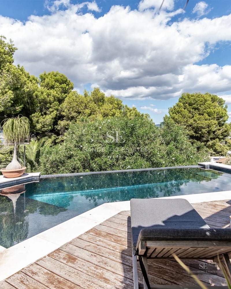 Spacious terrace with pool and panoramic views. Modern architecture, elegant furnishings, and abundant natural light.