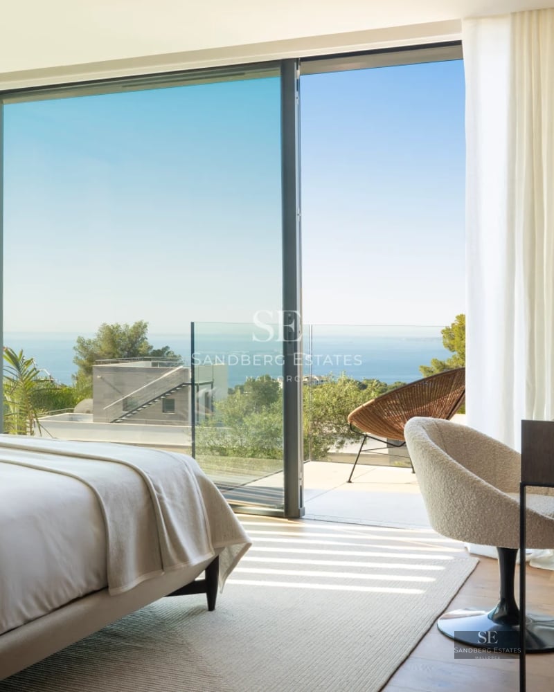 Spacious living room with balcony, panoramic views. Bright, elegant and modern interior. Wood floors, minimalist decor.