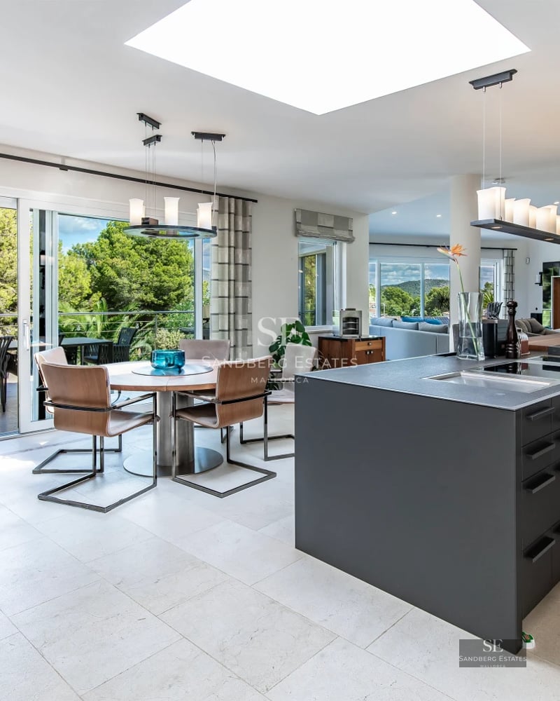 Panoramic view of an infinity pool surrounded by lush vegetation. Modern and elegant design. Warm ambient lighting.