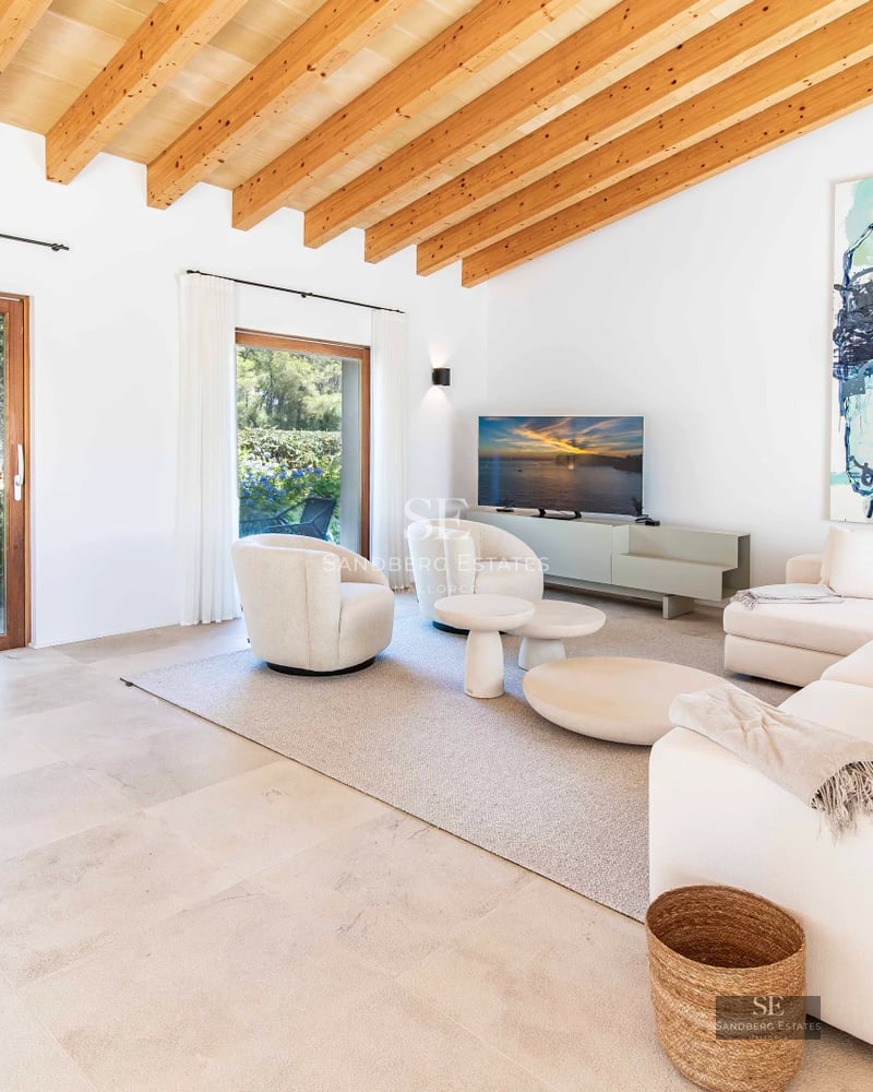 Spacious living room with large windows, designer sofas, stylish coffee table, and panoramic sea views. Bright and modern.