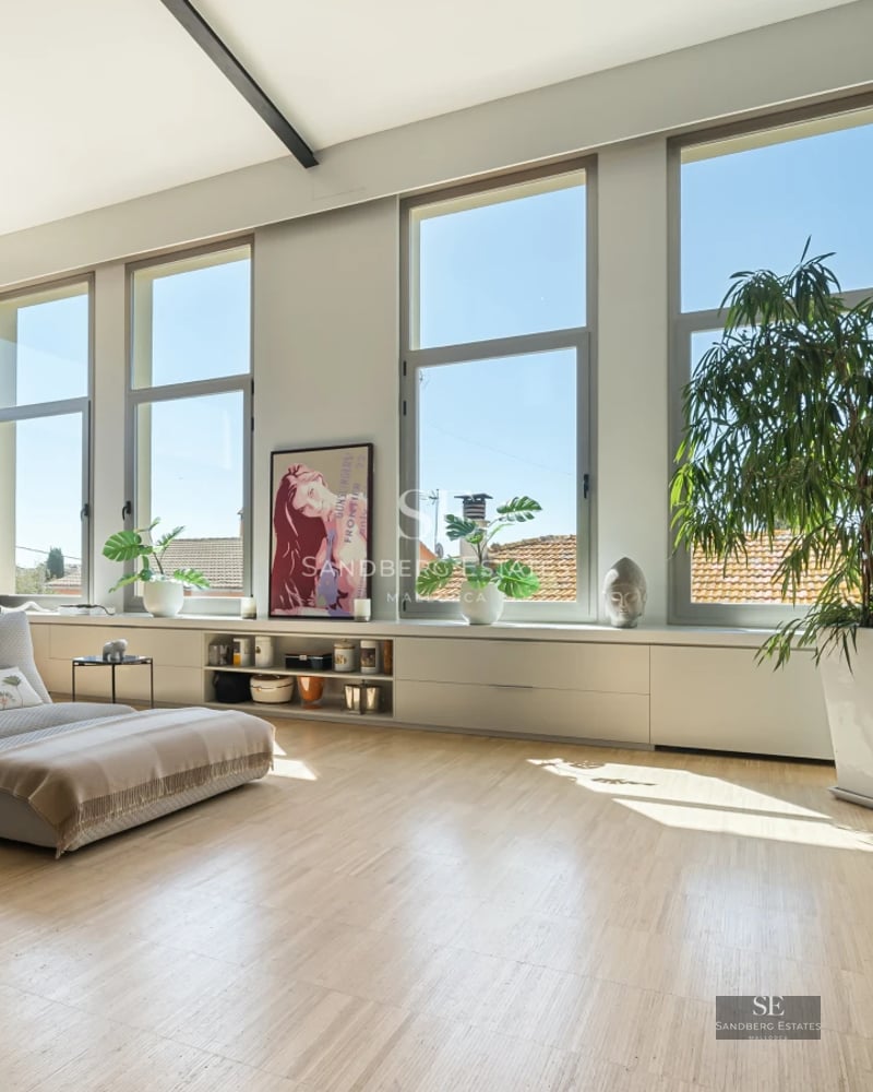 Spacious terrace with panoramic sea views, modern furniture, glass railing, wooden floor. Luxurious and relaxing atmosphere.