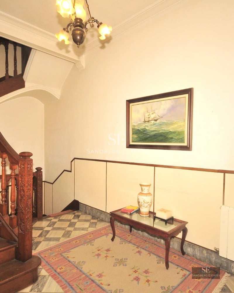 Spacious living room with floor-to-ceiling windows, light wood floor, modern fireplace, and garden view. Minimalist design and natural light.