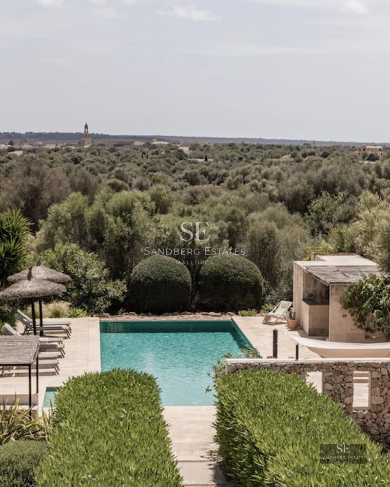 Image of a modern villa with a pool, large windows, and elegant landscaping. Minimalist design with natural touches.