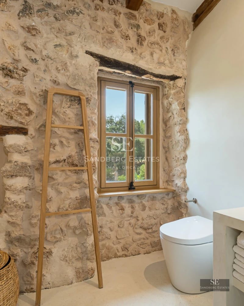 Exterior view of a modern villa with a pool, lush garden, and elegant architecture. White facade, large windows, and manicured landscaping.