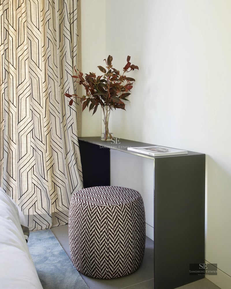 Aerial view of a modern villa with infinity pool, surrounded by lush gardens and panoramic views. Minimalist architecture and high-end finishes.