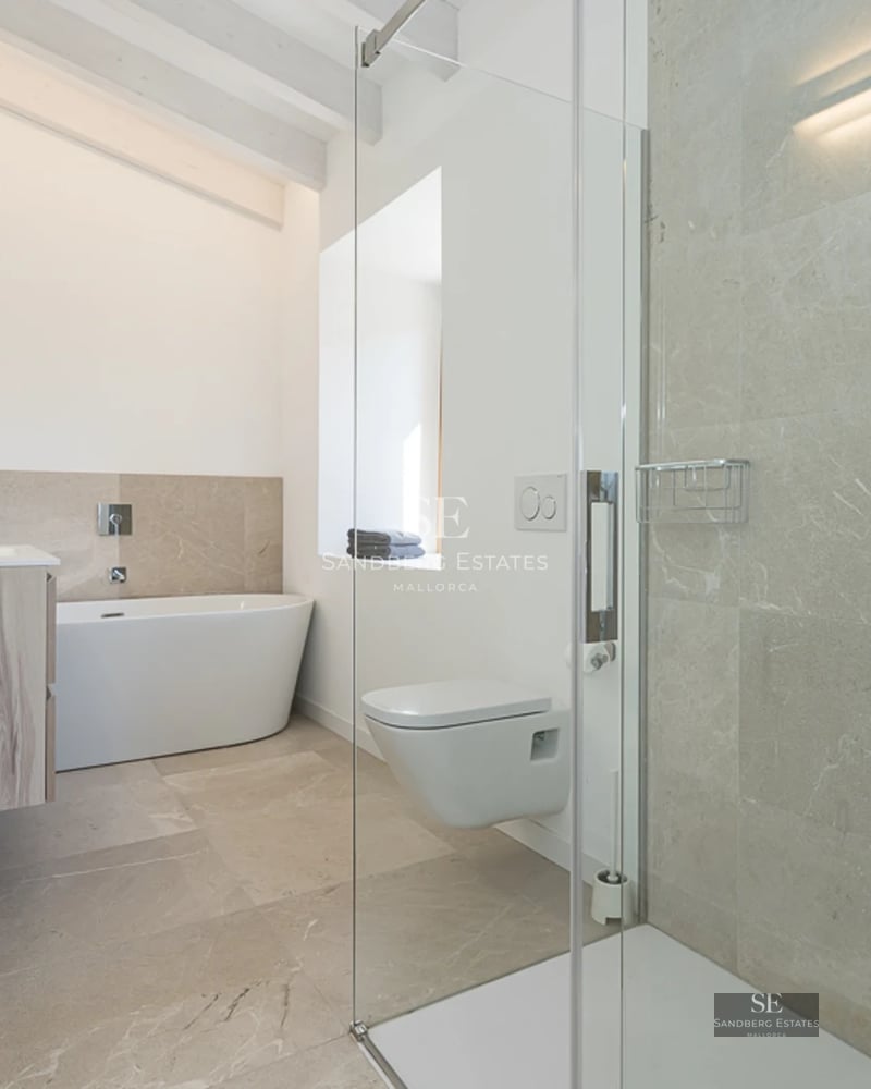 Pool view featuring sun loungers, lawn, modern villa with large windows and blue sky. Minimalist architecture, natural light.
