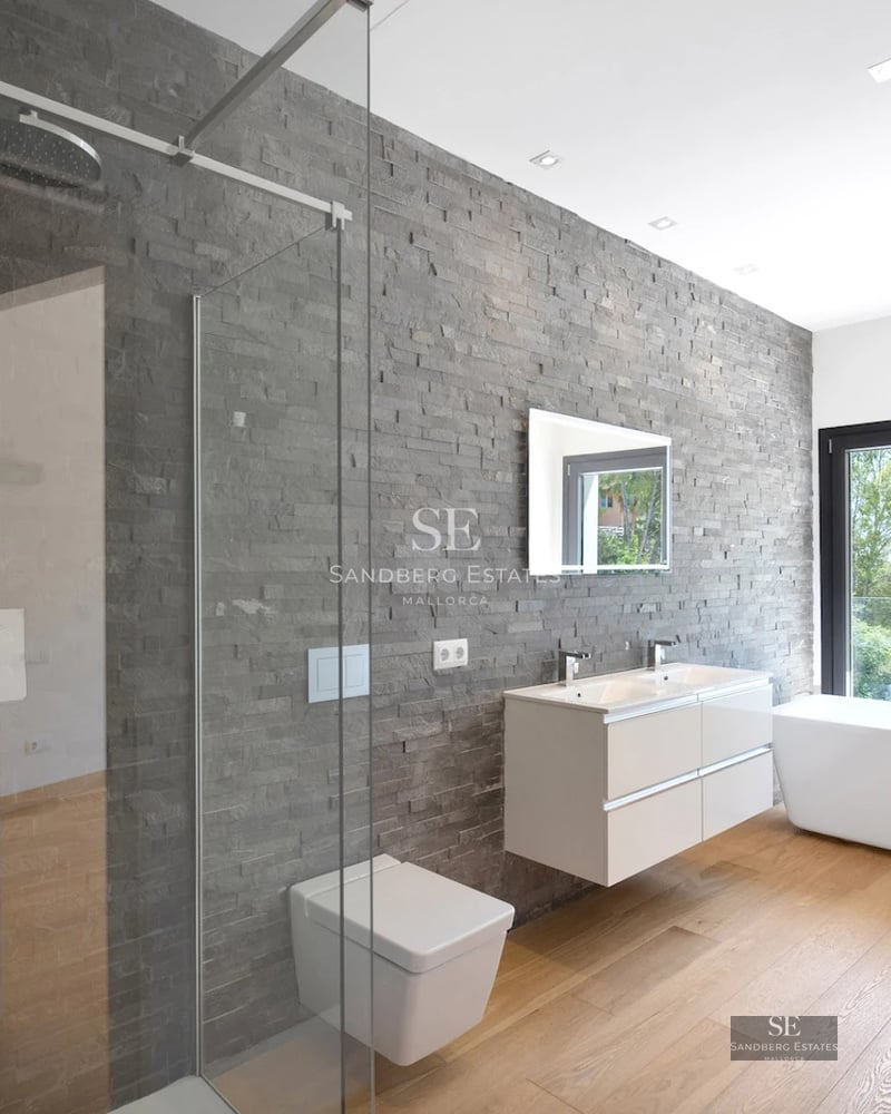 Spacious living room with floor-to-ceiling windows, light wood floors, modern fireplace, and terrace access with panoramic views. Minimalist, elegant design.