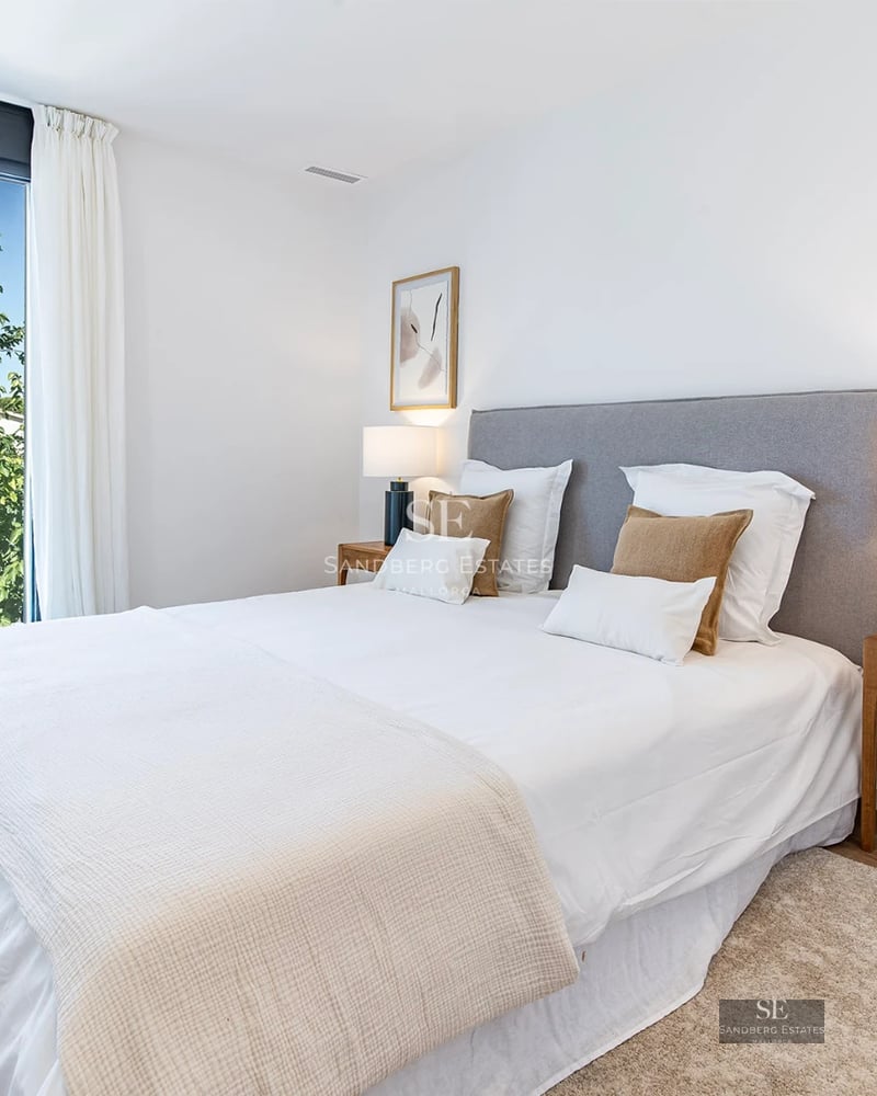 View of the villa with infinity pool, gardens, ambient lighting, and modern architecture. Spacious areas and elegant design.