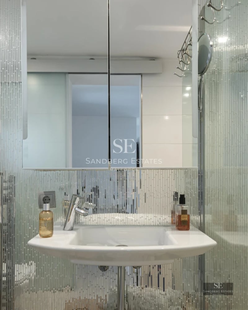 Exterior view of a modern villa featuring a pool, expansive terraces, lush vegetation and contemporary architecture.