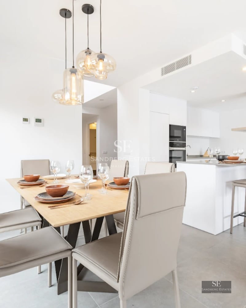 Spacious balcony with glass railing, panoramic sea view. Light floors and modern furniture.