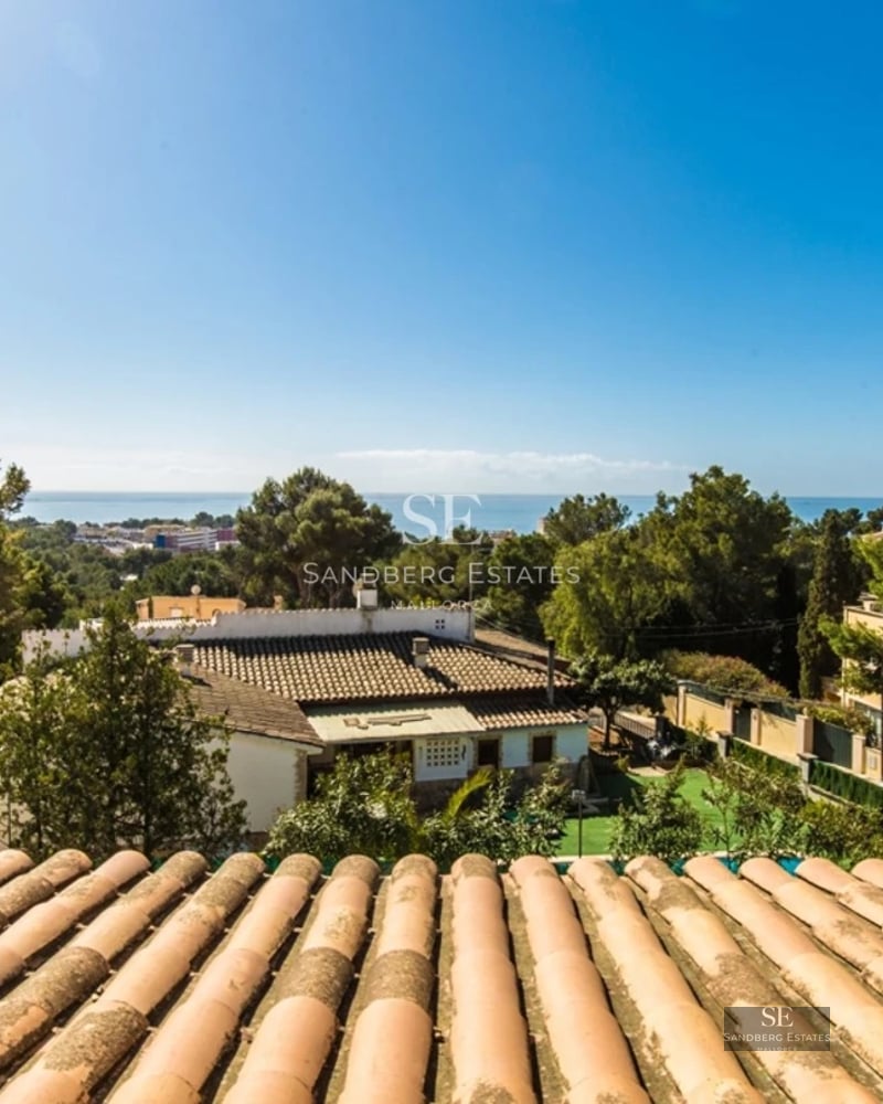 View of a modern villa with a pool, surrounded by greenery. Minimalist architecture, large windows, and elegant design.