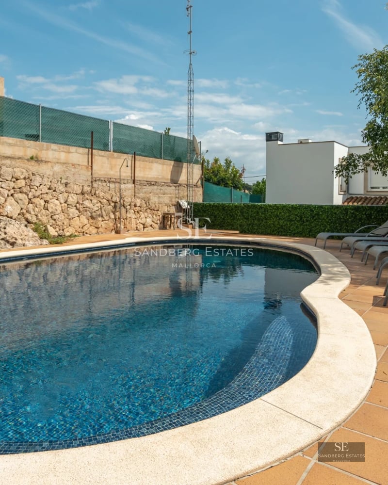 Spacious terrace with pool, sun loungers and scenic views. Modern architecture features large windows and minimalist design.