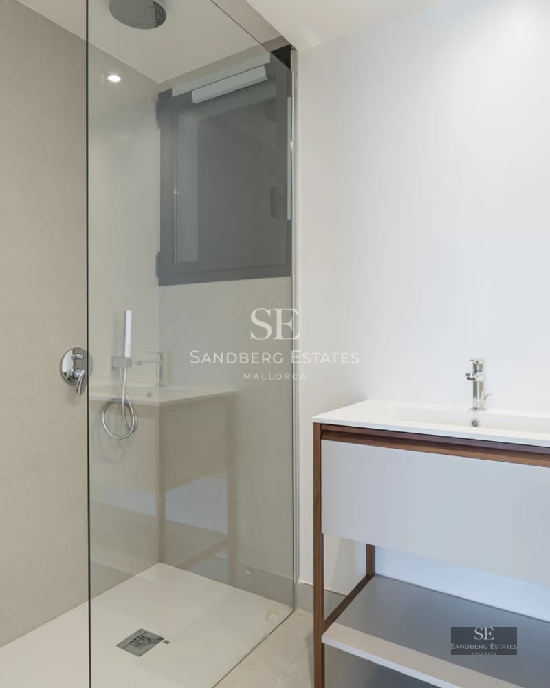 Spacious living room featuring panoramic windows, modern furniture, and balcony access. Breathtaking views. Abundant natural light.