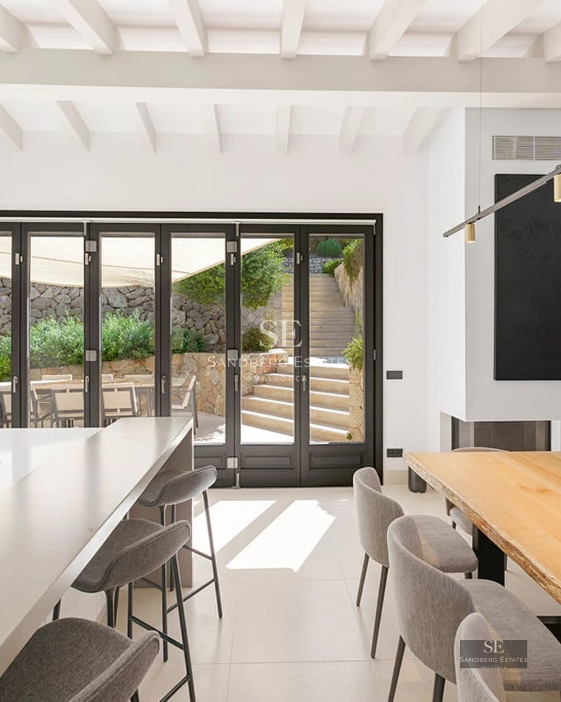 Expansive terrace with infinity pool, lounge chairs, umbrellas, and panoramic sea views. Modern and elegant design.