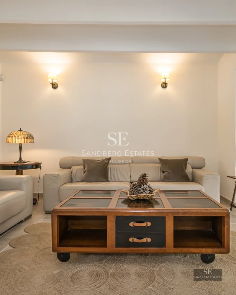 Spacious living room with large windows, modern fireplace, and designer furniture. Panoramic views and abundant natural light.