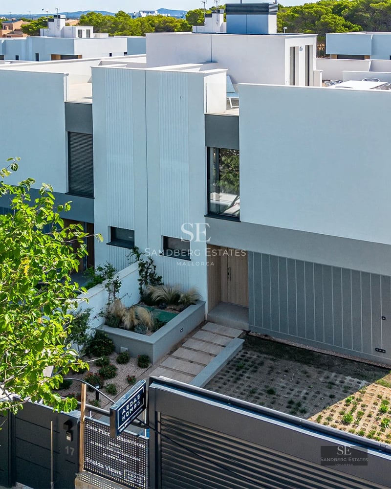 Spacious balcony with panoramic sea views from a modern apartment. Glass railing, minimalist furniture, and abundant natural light.