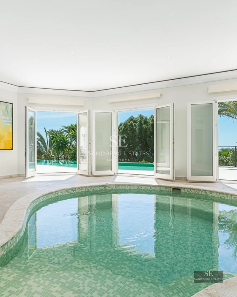 Expansive garden with reflecting pool, sun loungers, and modern architecture. Ideal for relaxation and outdoor entertainment.