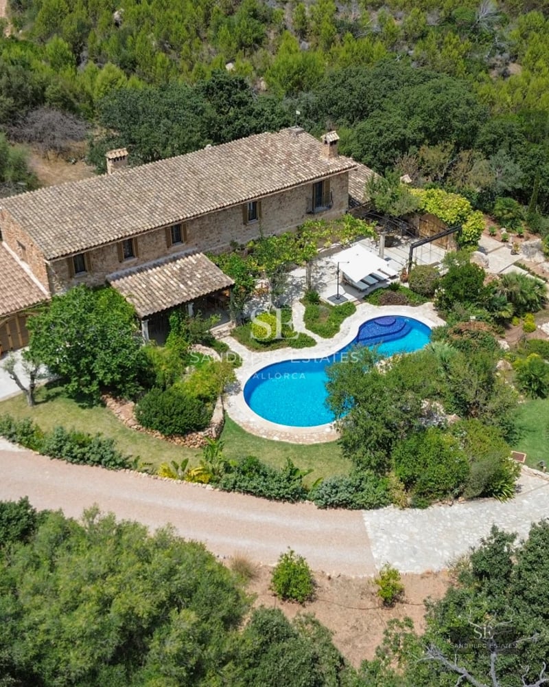 Exterior view of a modern villa with a pool, lush garden, and spacious terraces. Minimalist architecture with large windows.