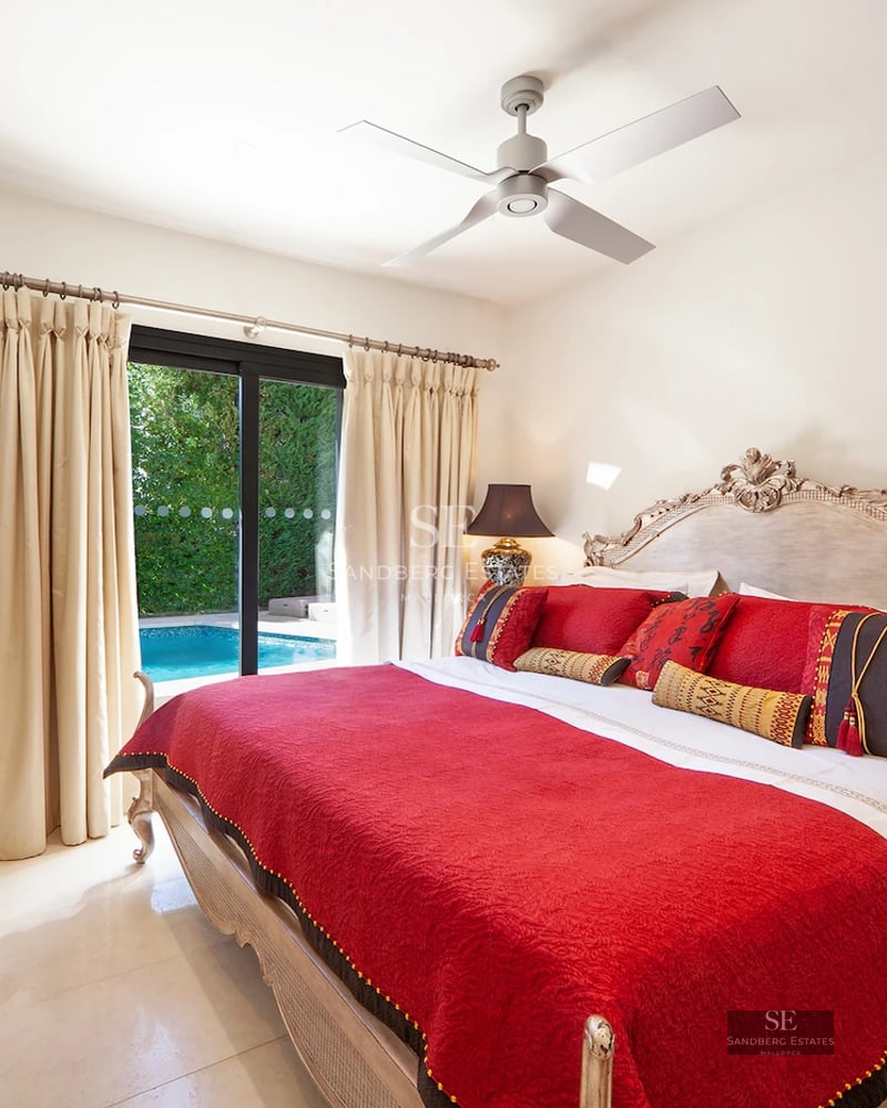 Exterior view of a modern house featuring a pool, lush garden, and minimalist architectural design. Large windows illuminate the interior.