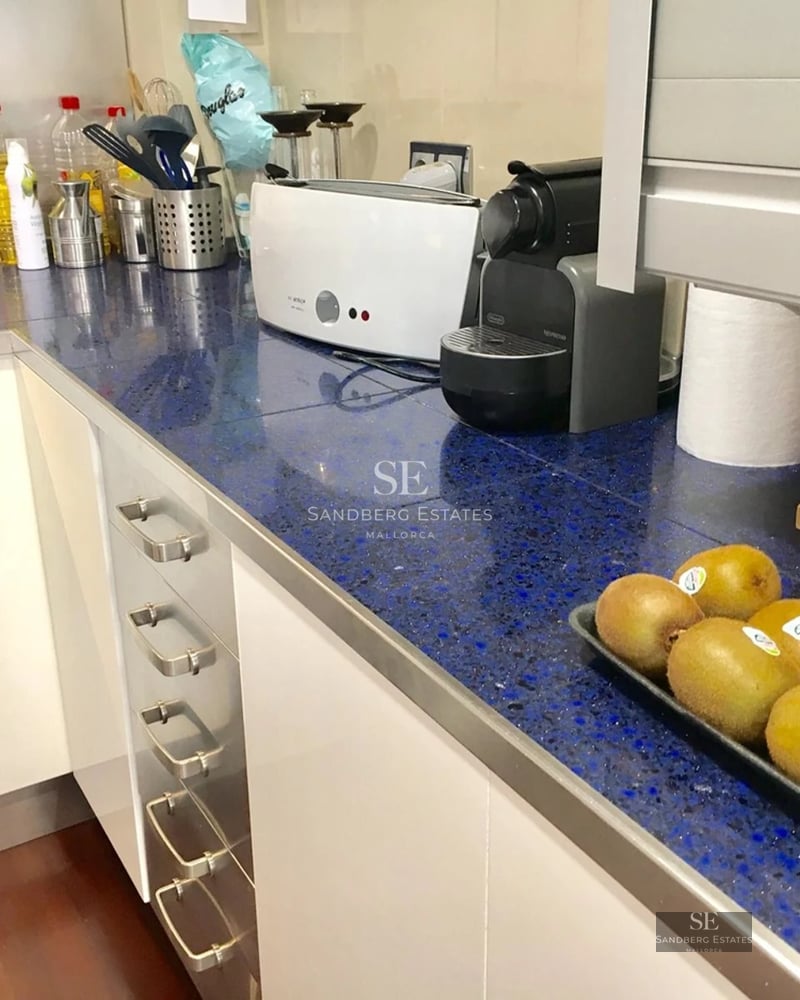 Modern terrace with pool, sun loungers, and panoramic sea views. Elegant furniture and minimalist design with spacious open areas.