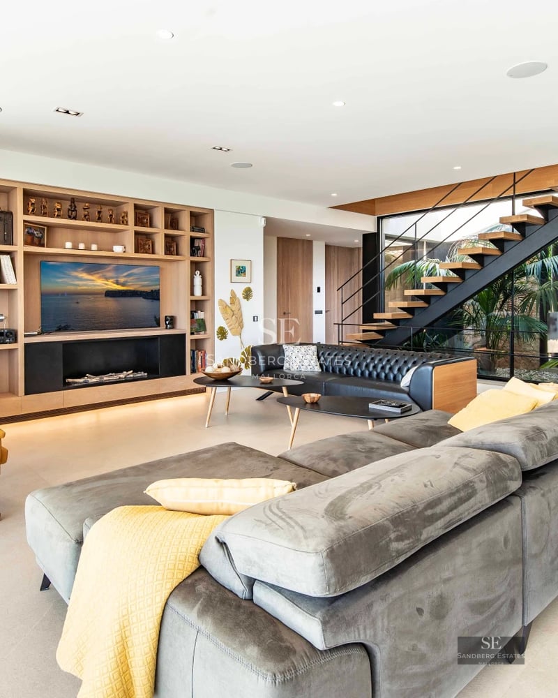 Spacious balcony with sea view, glass railing, modern outdoor furniture. Minimalist design, natural light.