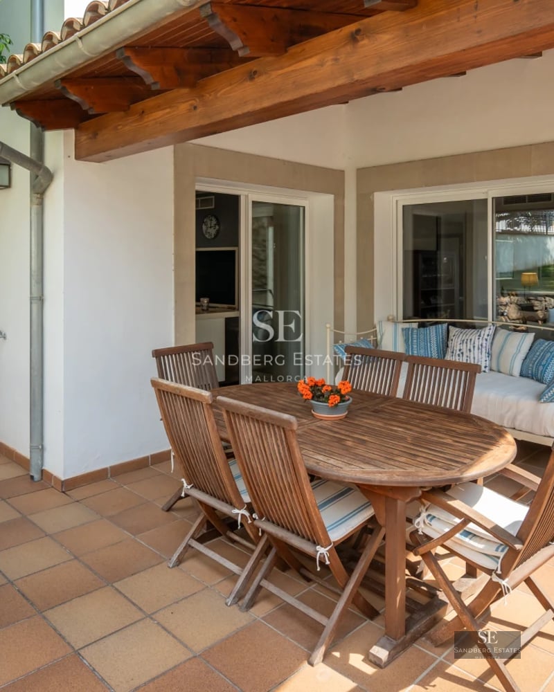 Exterior view of modern villa with infinity pool, lush garden, and large terraces. Minimalist architecture with large window fronts.