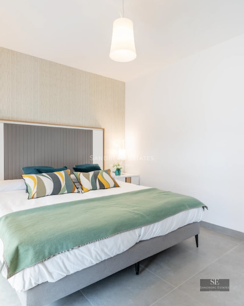 Exterior view of a modern house with infinity pool, lush garden, and sleek architecture featuring expansive windows.