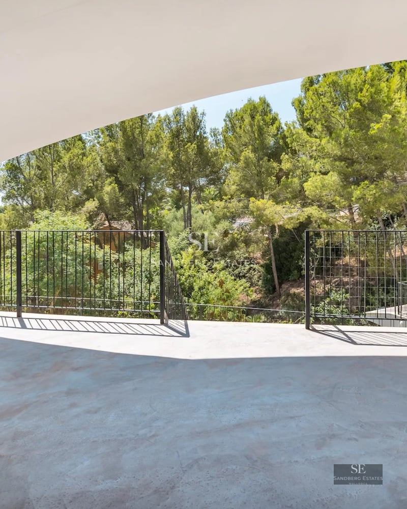 Spacious living room with large windows, infinity pool, and panoramic views. Modern design, natural lighting, and high-quality materials.