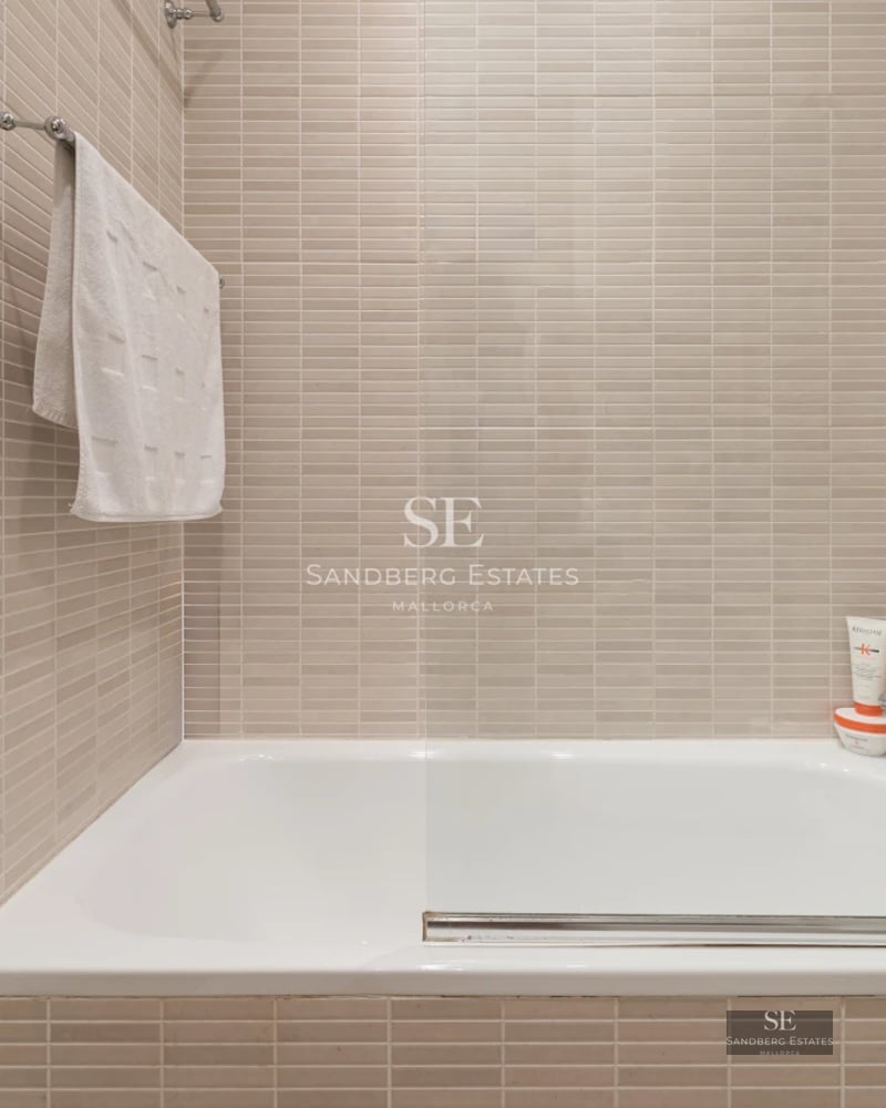 Exterior view of modern villa with infinity pool, lush garden, and minimalist architectural design.