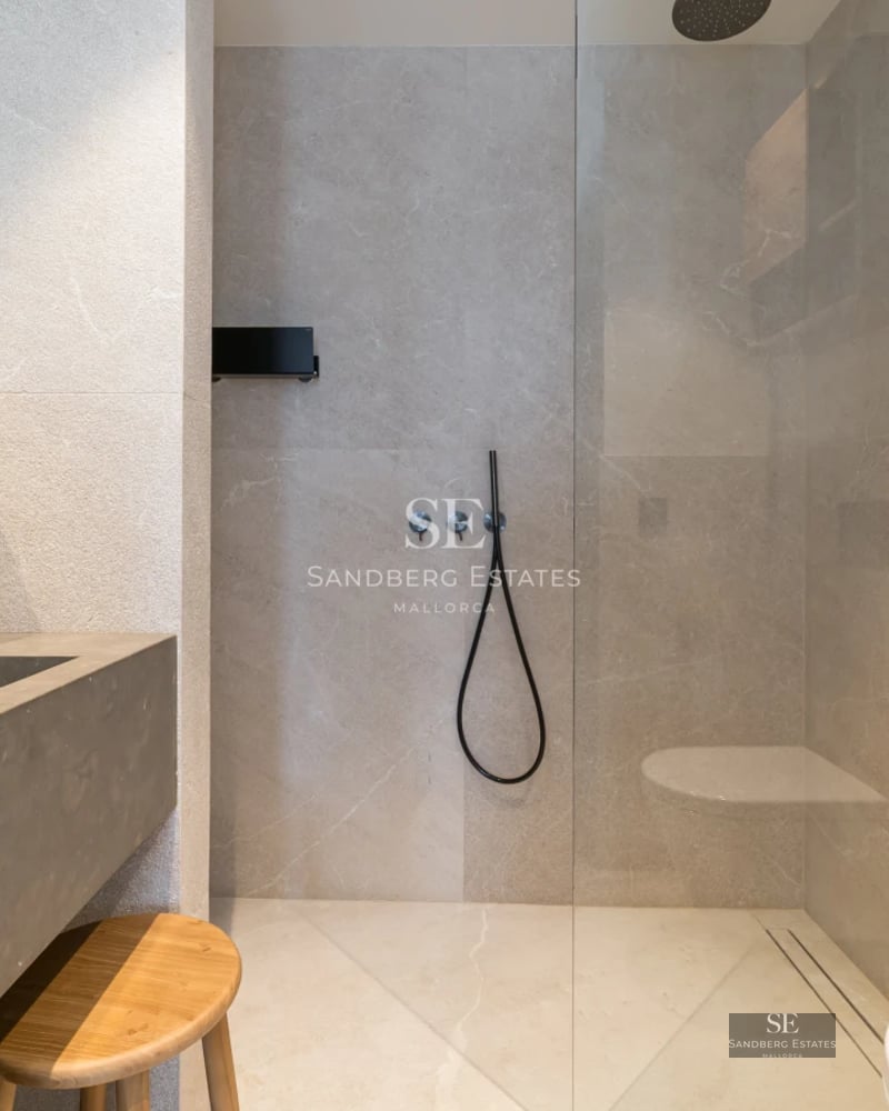 Exterior of a modern villa featuring an infinity pool, lush garden, and panoramic views. Clean and elegant architectural design.