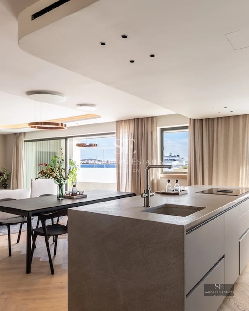 Infinity pool view with vanishing edge, surrounded by lush greenery. Modern design with ambient lighting.