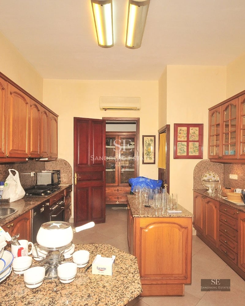 Spacious living room with sea view through panoramic windows. Modern design, light wood floors, white sofas and minimalist decor. Abundant natural light.