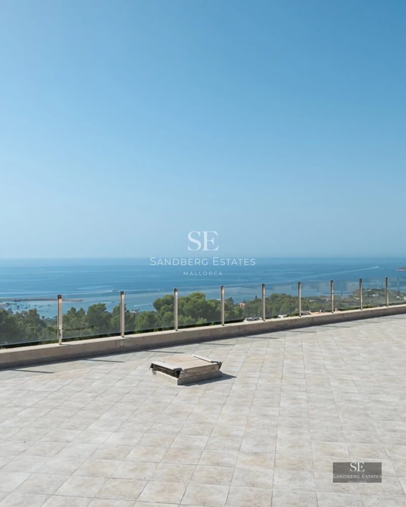 Spacious living room with direct pool access. Large windows, natural light, wood floors, and modern design.