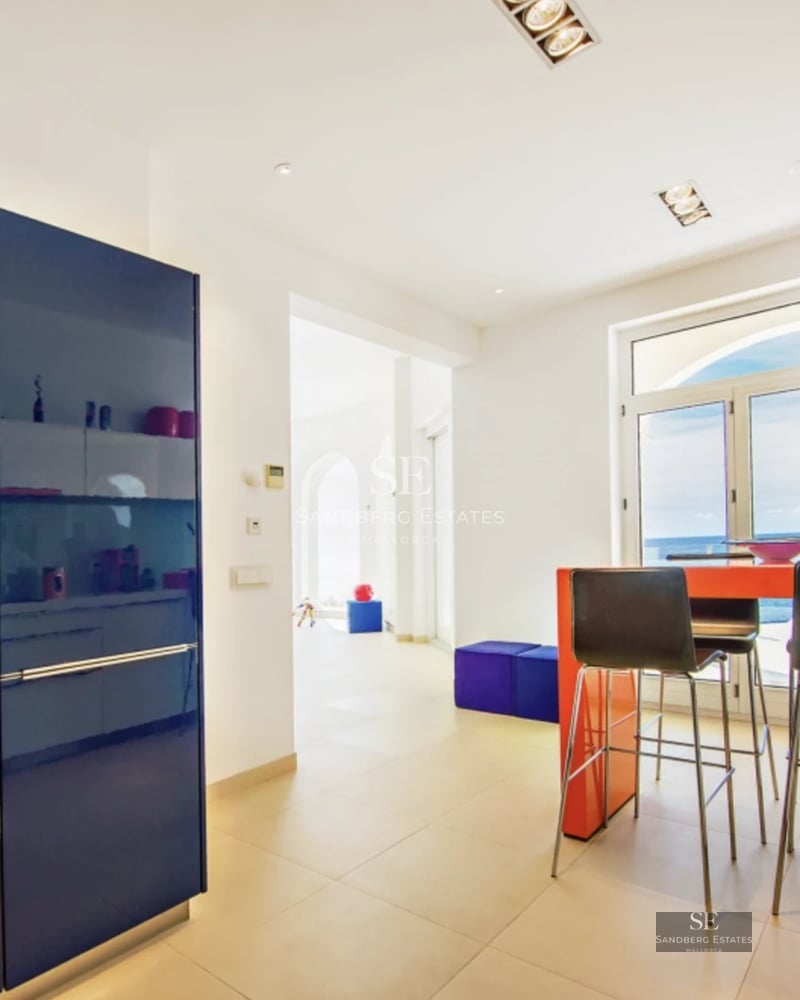 Exterior of a modern villa featuring a reflecting pool, large windows, and lush landscaping. Warm lighting.