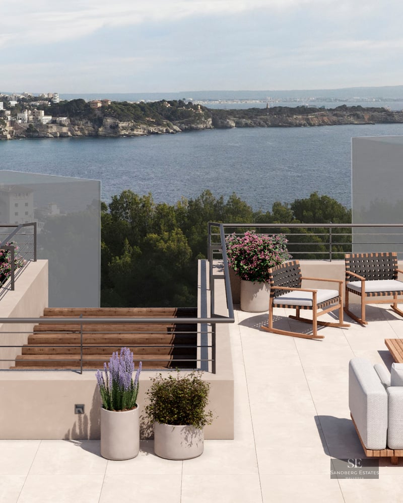 Spacious rooftop terrace with outdoor kitchen, dining area, and lounge seating overlooking the ocean.