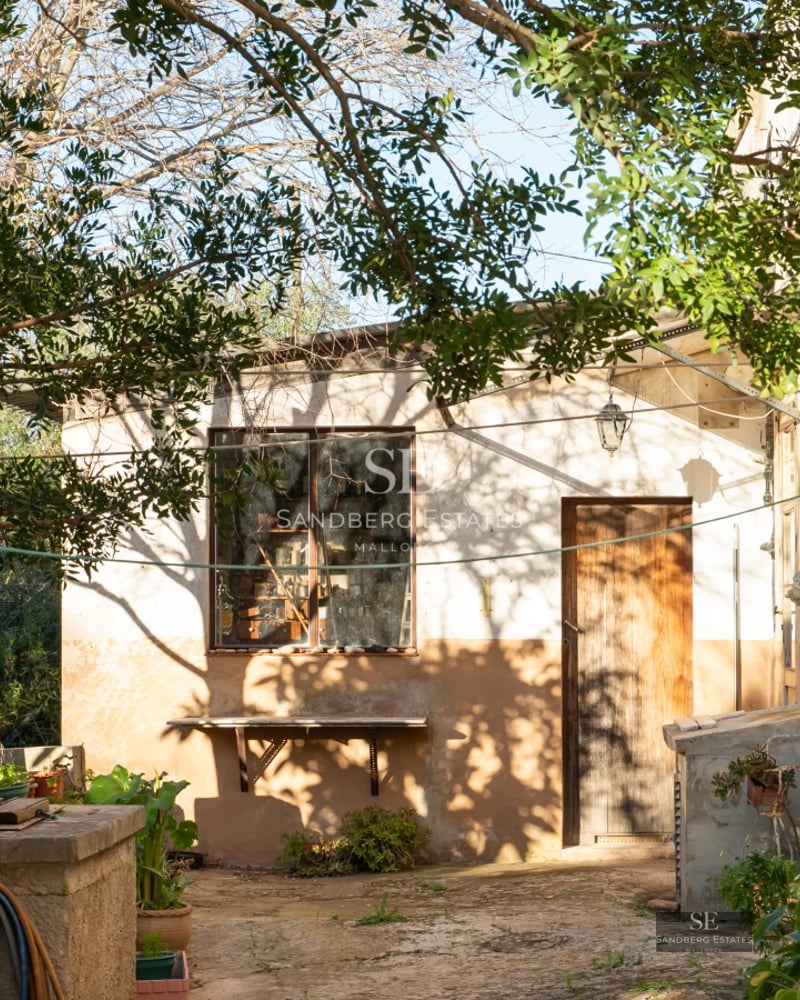 View of an elegant villa featuring an infinity pool, manicured garden, and modern design. Warm lighting and expansive outdoor spaces.