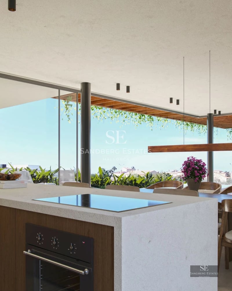 Spacious living room with sea view windows, light wood flooring, grey sofas, and minimalist decor. Abundant natural lighting.