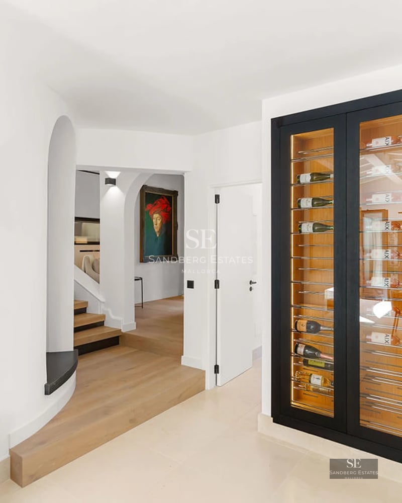 Modern penthouse featuring a spacious terrace, wooden flooring, glass railings, and panoramic sea views. Minimalist and elegant design.