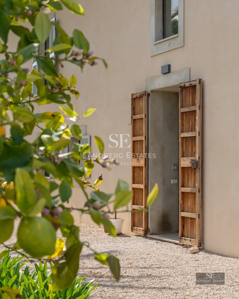 Exterior view of a modern villa featuring an infinity pool, landscaped garden, and spacious terraces. Contemporary design and high-end finishes.