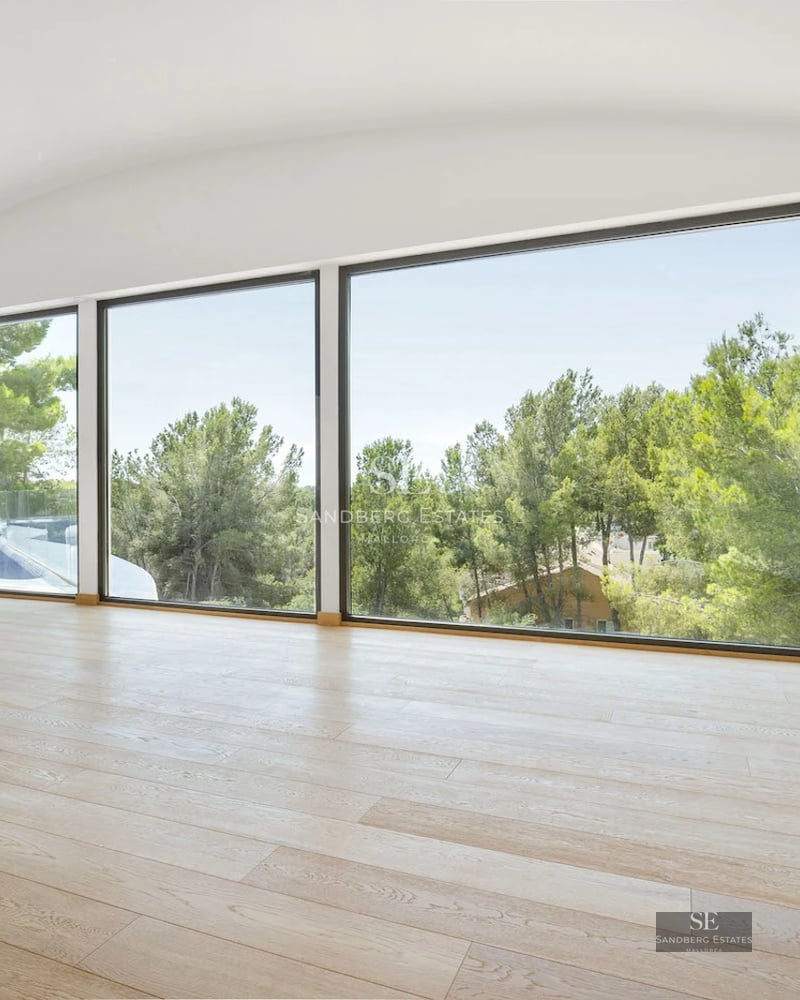 View of a modern villa featuring a pool and large windows. Minimalist architecture and sleek design with manicured landscaping.