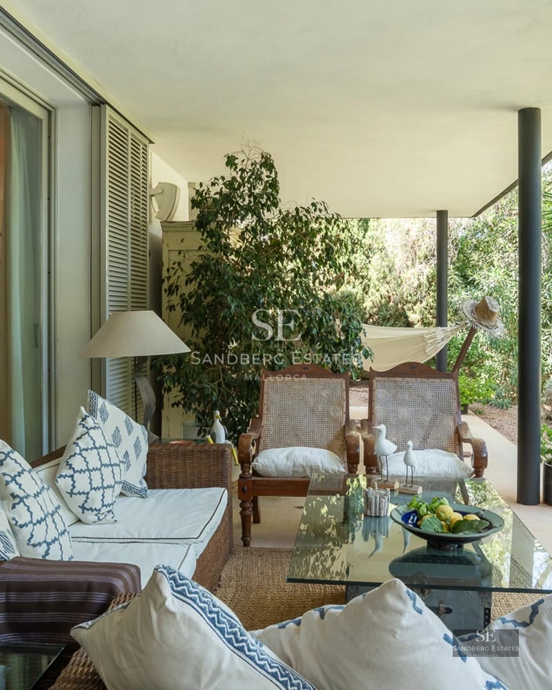 Bright interior with balcony and sea view. Modern furniture, wooden floors and large windows.