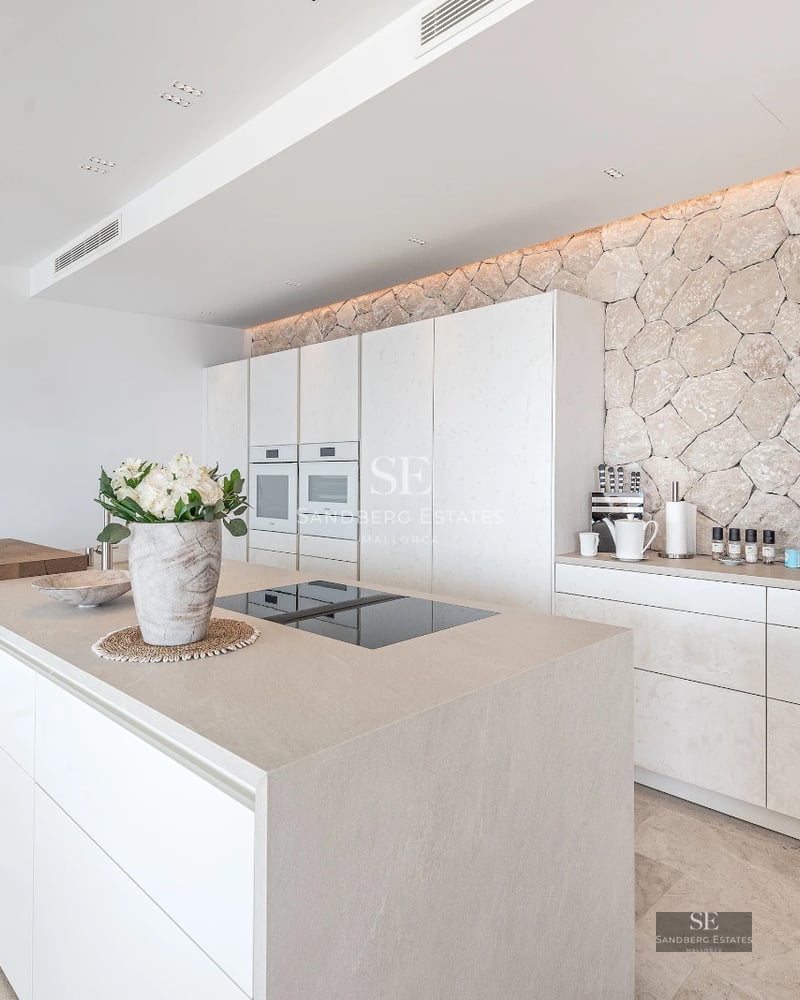 Spacious living room with large windows, outdoor pool and lush garden. Modern and bright design.