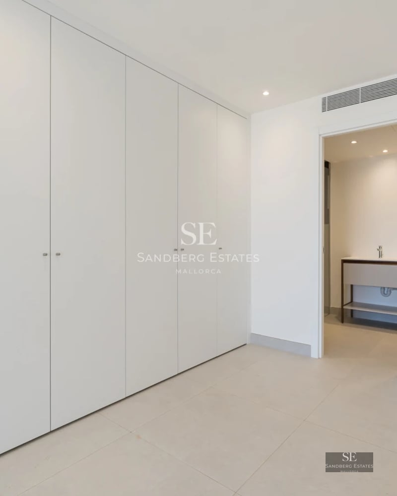 View of modern balcony with sparkling pool. Natural lighting, glass railing, and panoramic views. Minimalist design.