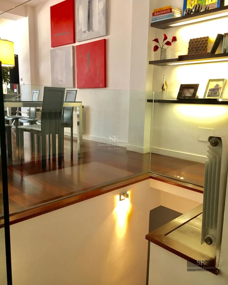 Exterior view of a modern villa featuring a swimming pool, sun loungers, and lush garden. Contemporary architectural design.